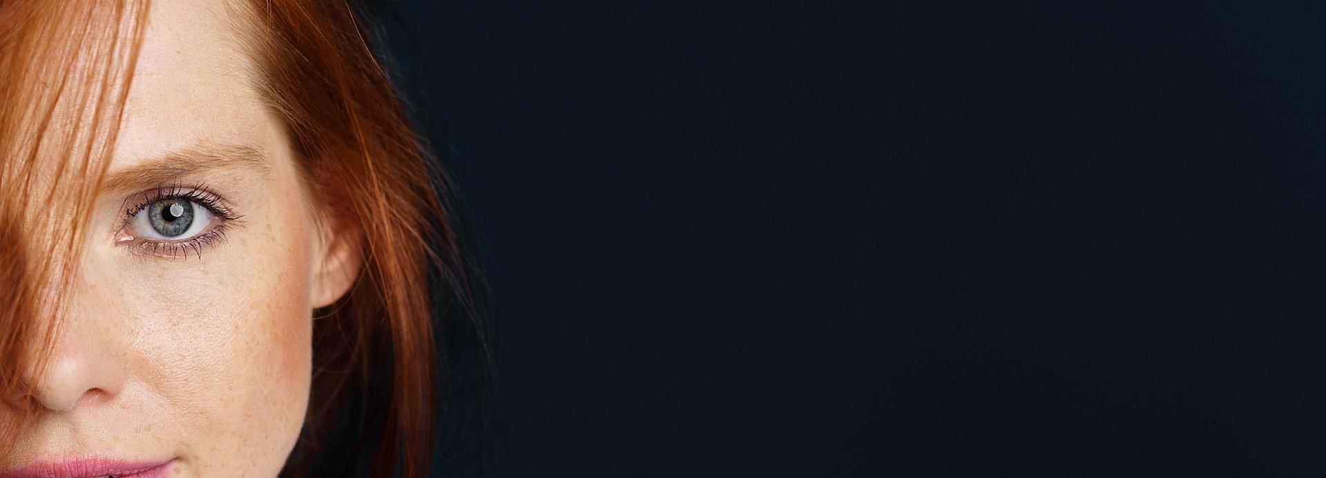 Close-up of a human eye showcasing vibrant color and freckles, emphasizing natural beauty and emotion against a dark background. Close-up of a human eye showcasing vibrant color and freckles, emphasizing natural beauty and emotion against a dark background.